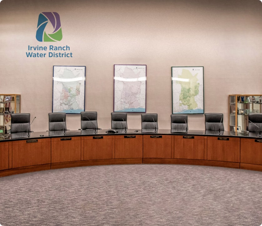 Irvine Ranch Water District boardroom with framed maps on the wall and a curved wooden conference table.