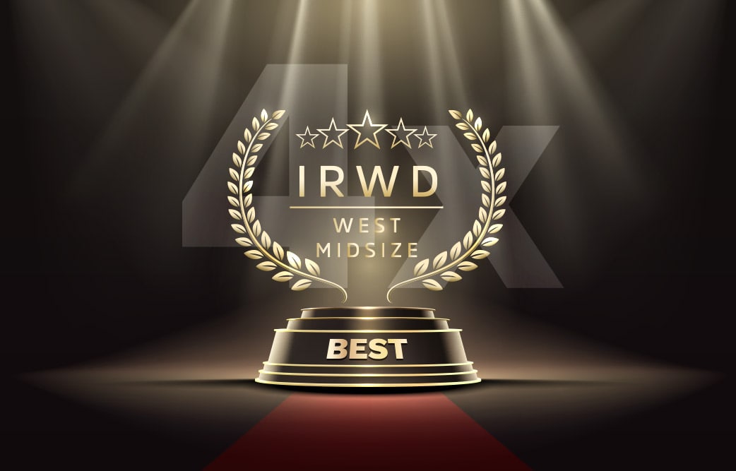 Gold award pedestal with laurel wreaths and 'BEST' on a red carpet under spotlight.