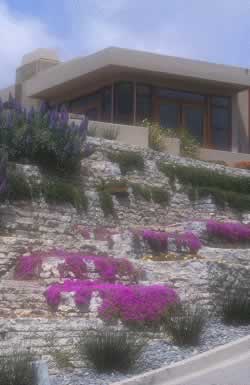 Modern hillside villa with stone terrace steps and vibrant purple bougainvillea against a blue sky.
